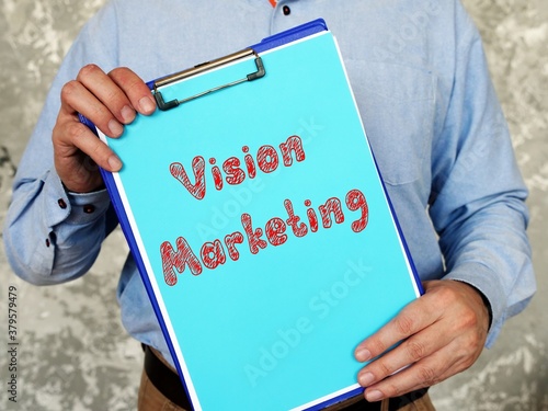 Фотография Financial concept meaning Vision Marketing with phrase on the piece of paper
