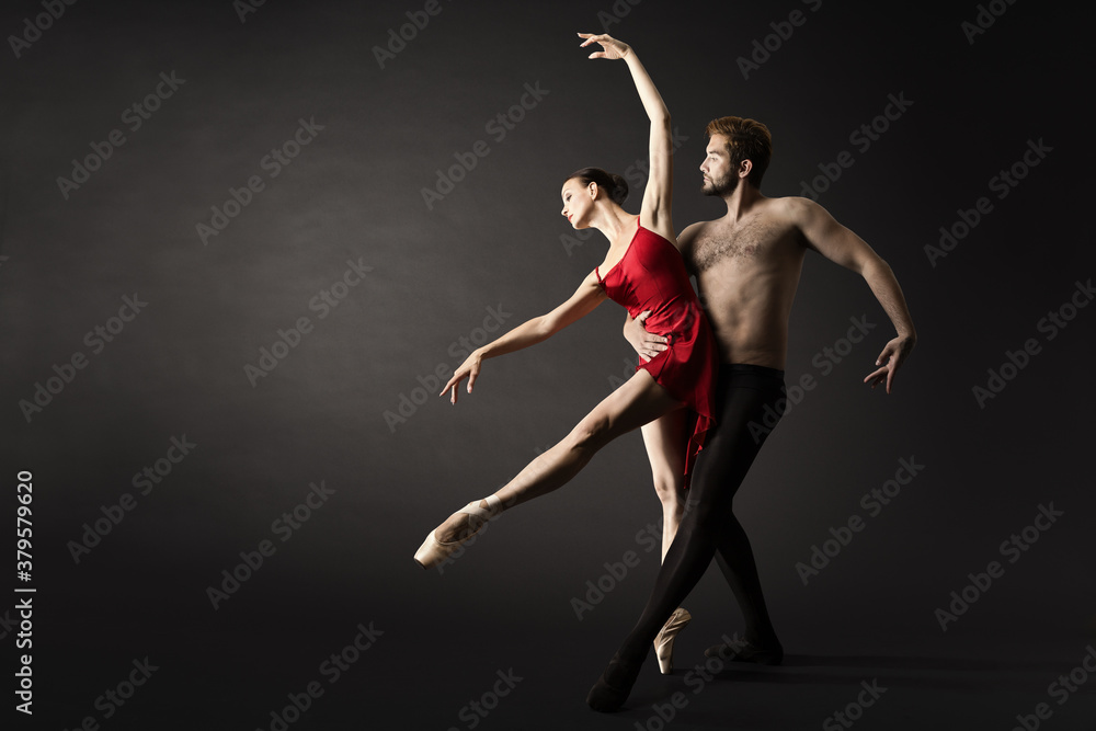 Ballet Dancers. Modern Ballerina Couple Posing over Gray Background