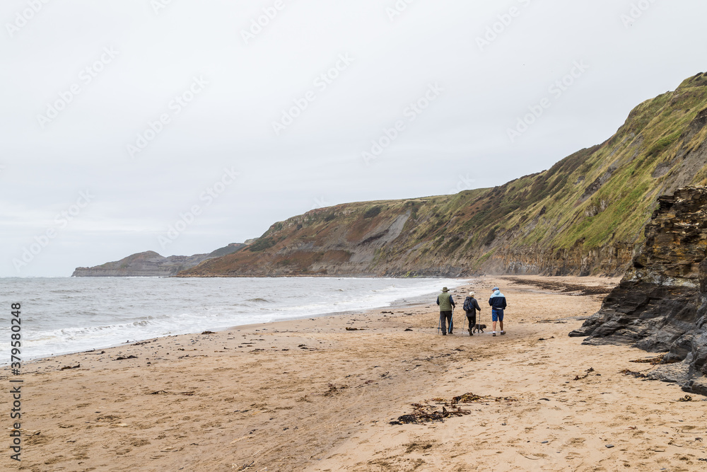 Walkers enjoying the beach at Runswick Bay