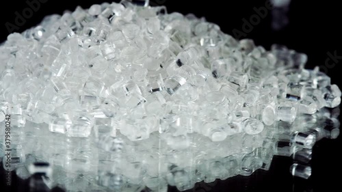 Close Up Clear Plastic Polymer Granules on black background