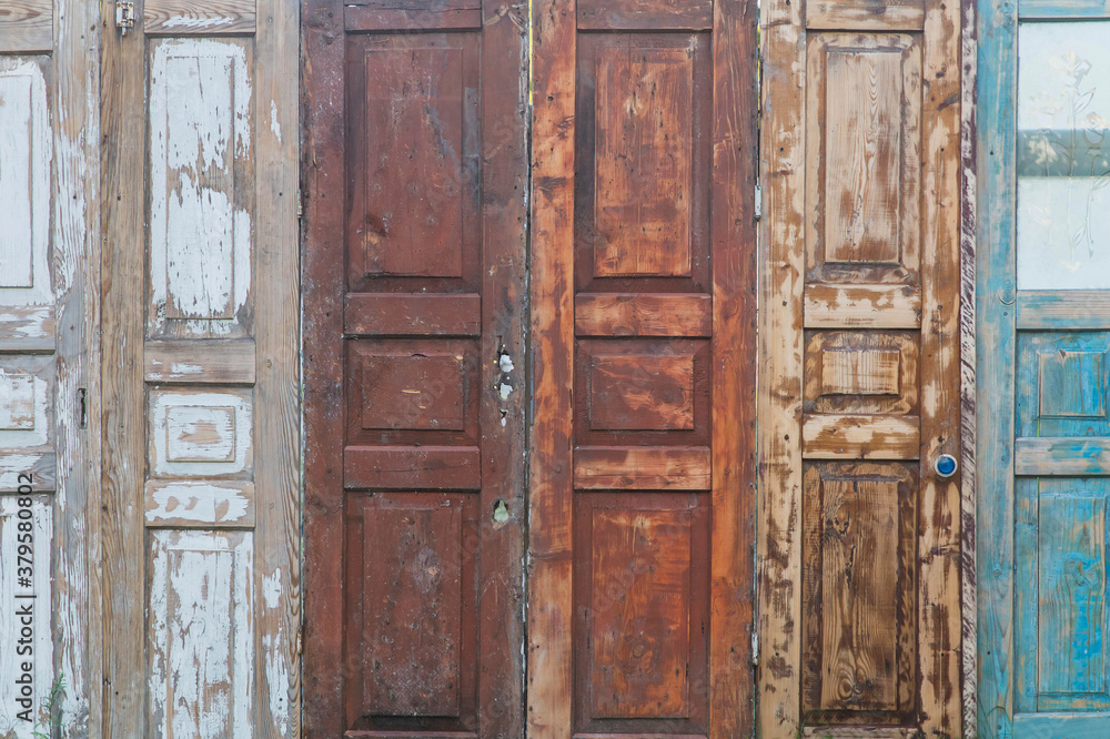 fence made of old doors with peeling paint fence made of old doors with peeling paint