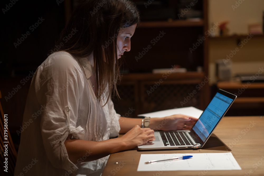 young woman with white shirt studies with computer on the table young woman with white shirt studies with computer on the table