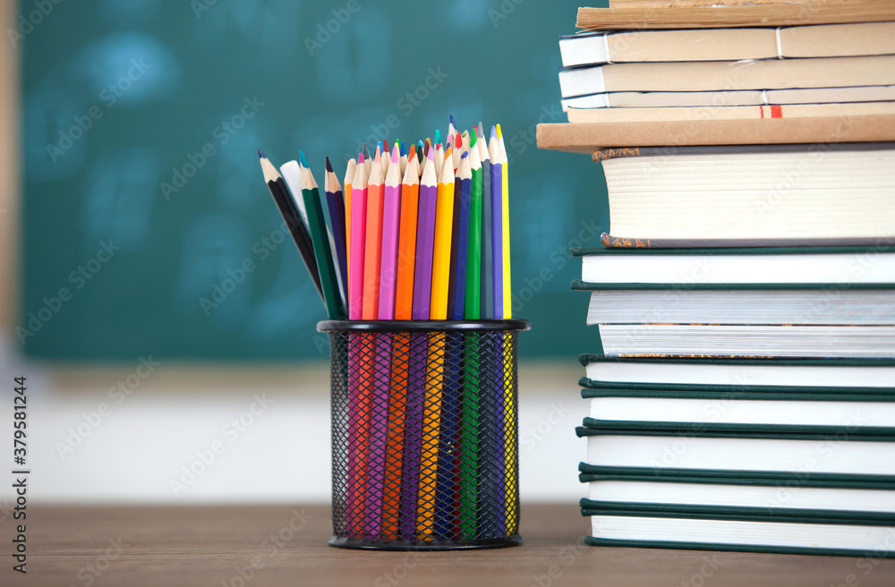 Stack of books and pencils in pen holder Stack of books and pencils in pen holder