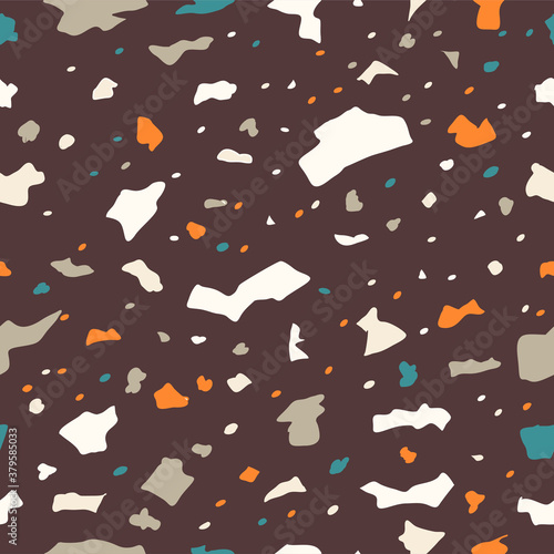 Background Terrazzo seamless pattern with motley stone or rock fractions. Elegant backdrop with mineral crumbs scattered on a light background.