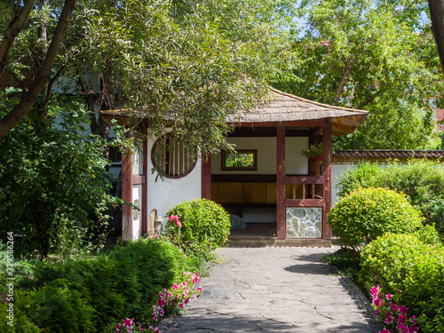 Japanese traditional gazebo in the park. Landscaping. Summer sunny day