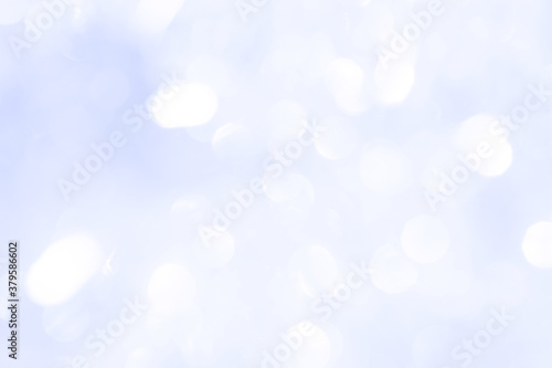 Bokeh light on blue background, sky with circle glitter light blue. Snow abstract soft glowing with vivid bright light and bokeh blur effect. 