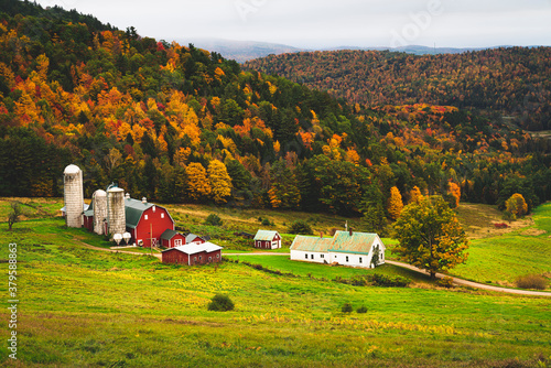 Rustic farm scene in rural vermont during autumn with fall colors changing and a bountiful harvest and a traditional American scene depicting home for the holidays