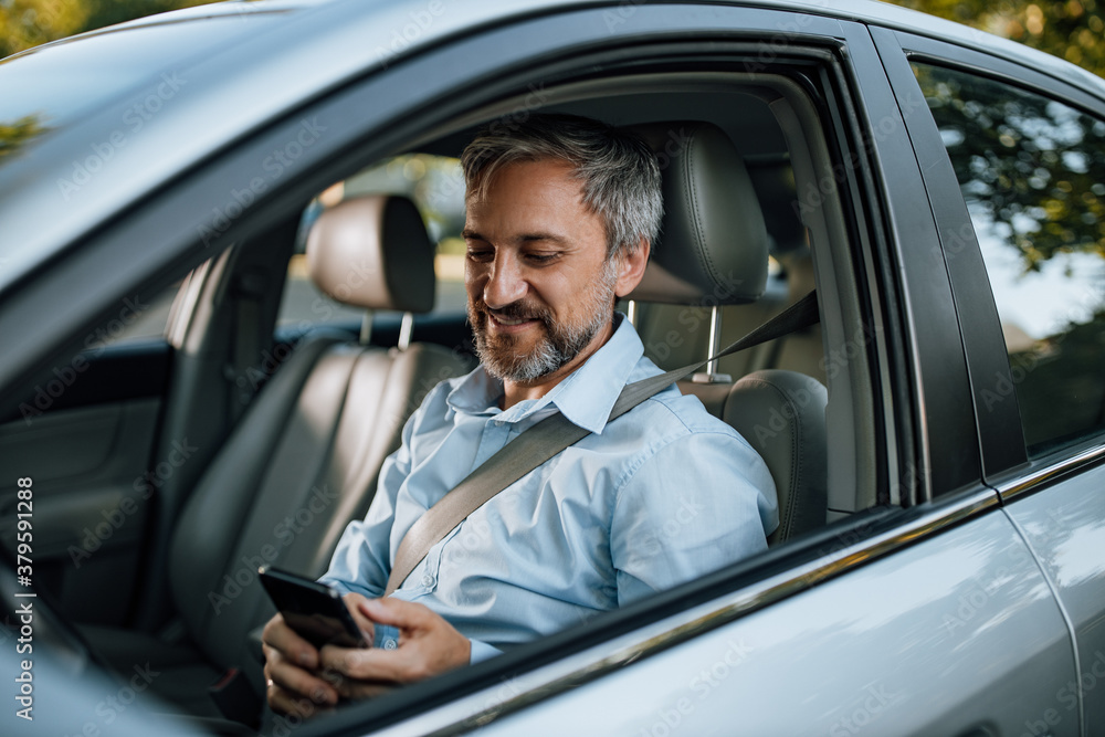 Man using phone while sitting in the car.