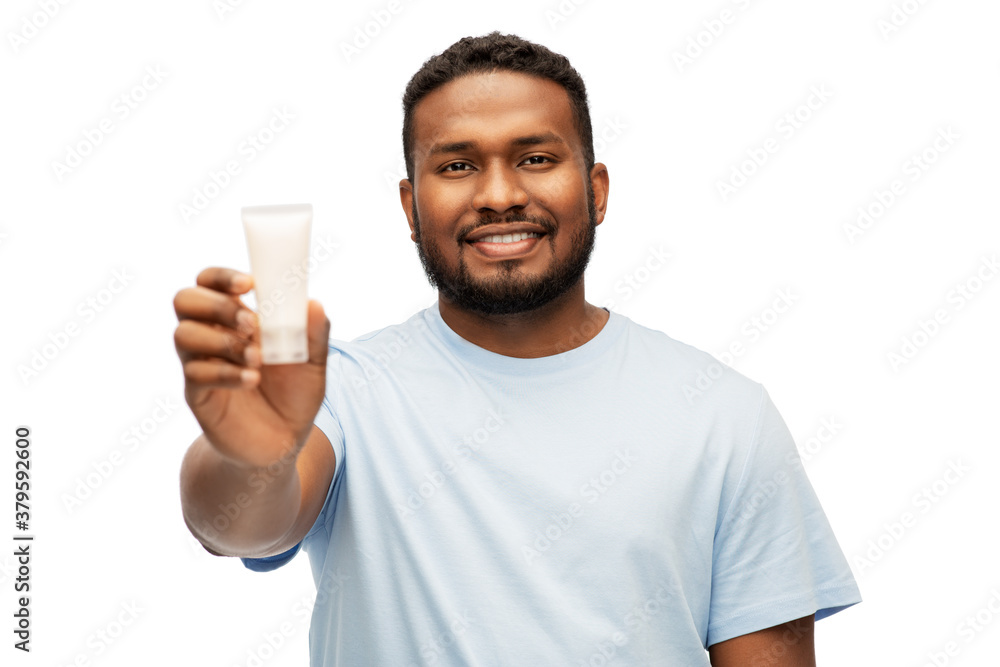 grooming, skin care and people concept - happy smiling african american showing moisturizer over white background grooming, skin care and people concept - happy smiling african american showing moisturizer over white background