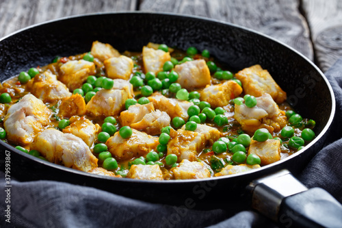 fish curry with green peas, top view