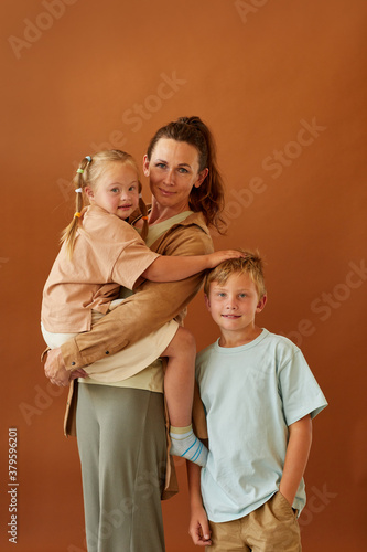 Obraz na plátne Vertical portrait of happy mature mother holding daughter with downs syndrome an
