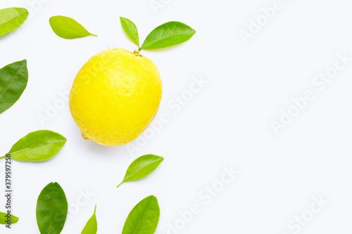 Fresh lemon with green leaves on white.