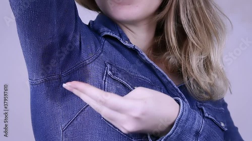 Businesswoman sweating excessively smelling bad in the office at work. Hyperthyroidism concept