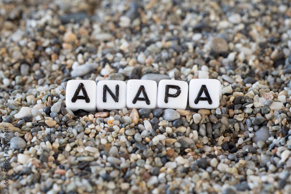 Anapa inscription text with name of the vacation destination city in a still life of the letters layed out on a shore sand stones. Anapa inscription text with name of the vacation destination city in a still life of the letters layed out on a shore sand stones.
