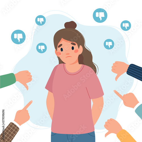 Sad young woman surrounded by hands with thumbs down and pointing fingers. Guilt, shame and social disapproval concept