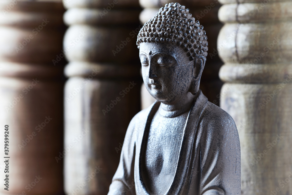 Meditating Buddha Statue on bright background. Close up.	