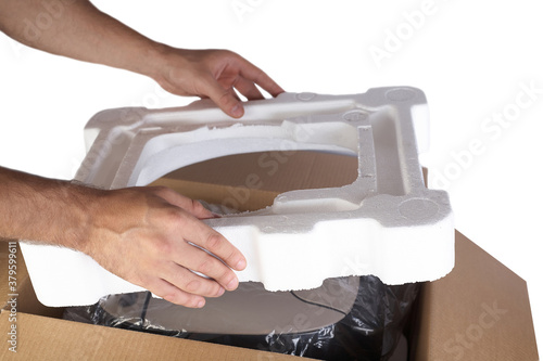 Foto Packing goods in cardboard box with styrofoam material for safe transportation of cargo