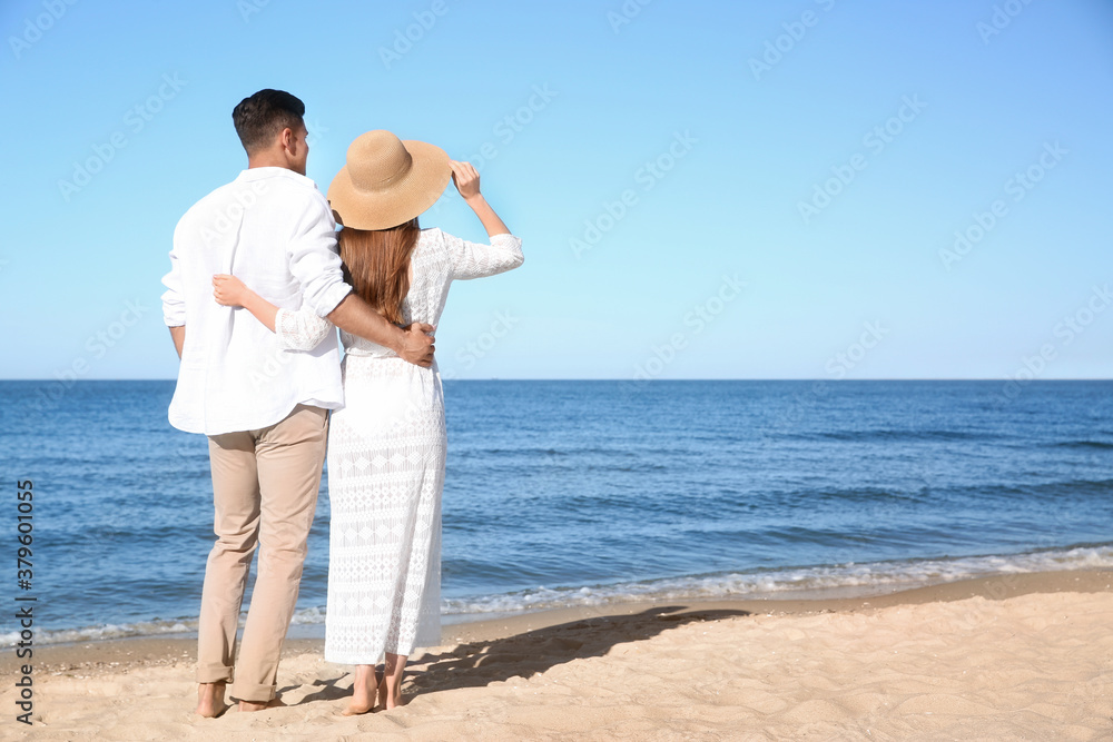 Lovely couple on beach. Space for text