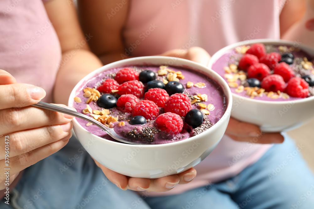 Women with tasty natural acai smoothie, closeup Women with tasty natural acai smoothie, closeup
