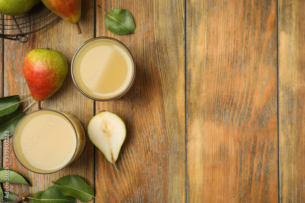 Tasty pear juice, fruits and leaves on wooden table, flat lay. Space for text Tasty pear juice, fruits and leaves on wooden table, flat lay. Space for text