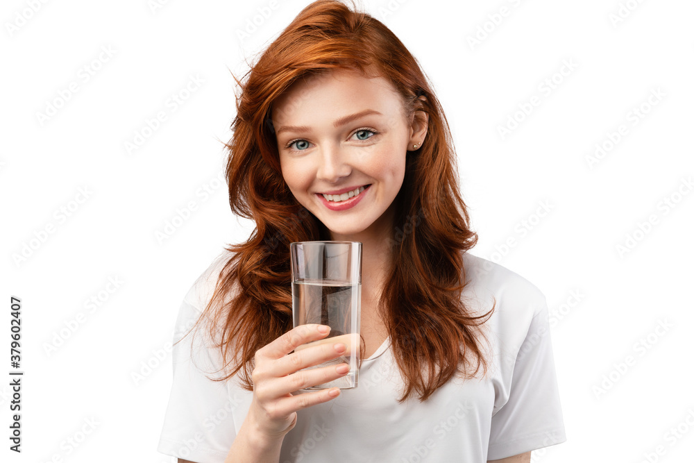 Ginger-Haired Young Woman Holding Glass Of Water Over White Background Ginger-Haired Young Woman Holding Glass Of Water Over White Background