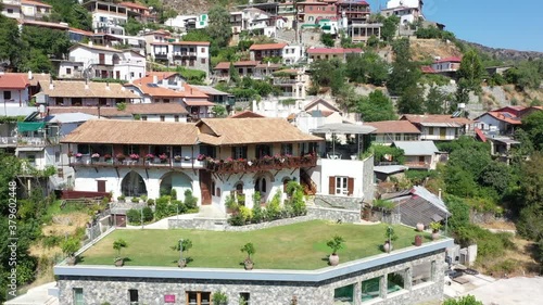 Village in the mountains, in a gorge, Greek, Italian, Spanish, southern, European. Houses with tiled roofs. The village stands on a steep mountainside photo