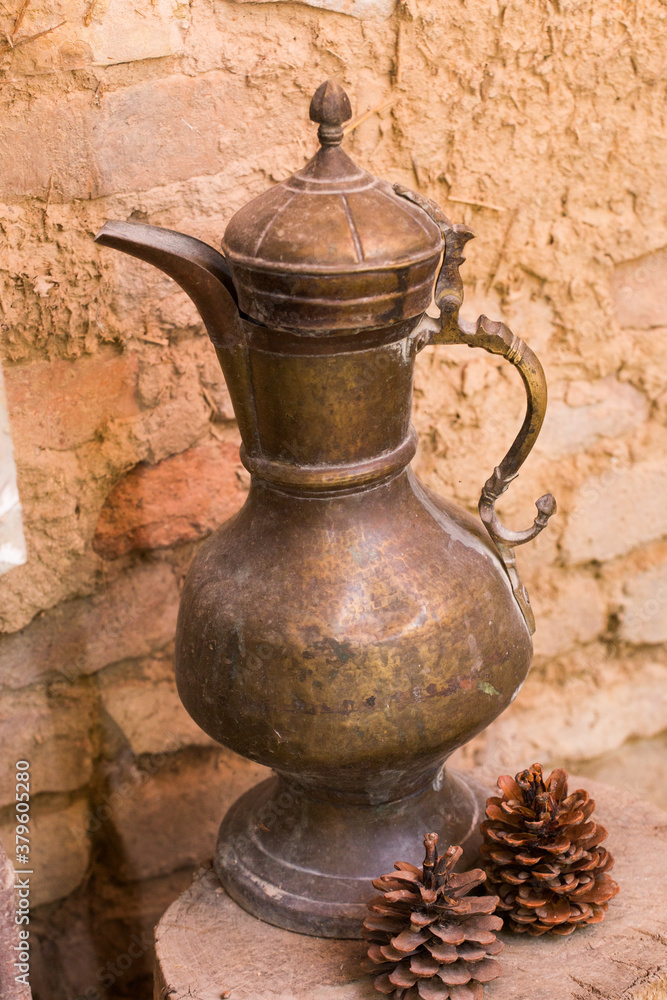 antique bronze dishes stands on a wooden stump antique bronze dishes stands on a wooden stump