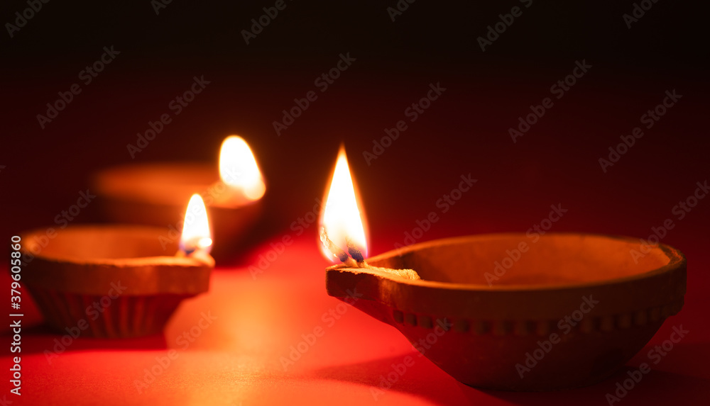 Happy Diwali - Clay Diya lamps lit during Dipavali, Hindu festival of lights celebration Happy Diwali - Clay Diya lamps lit during Dipavali, Hindu festival of lights celebration