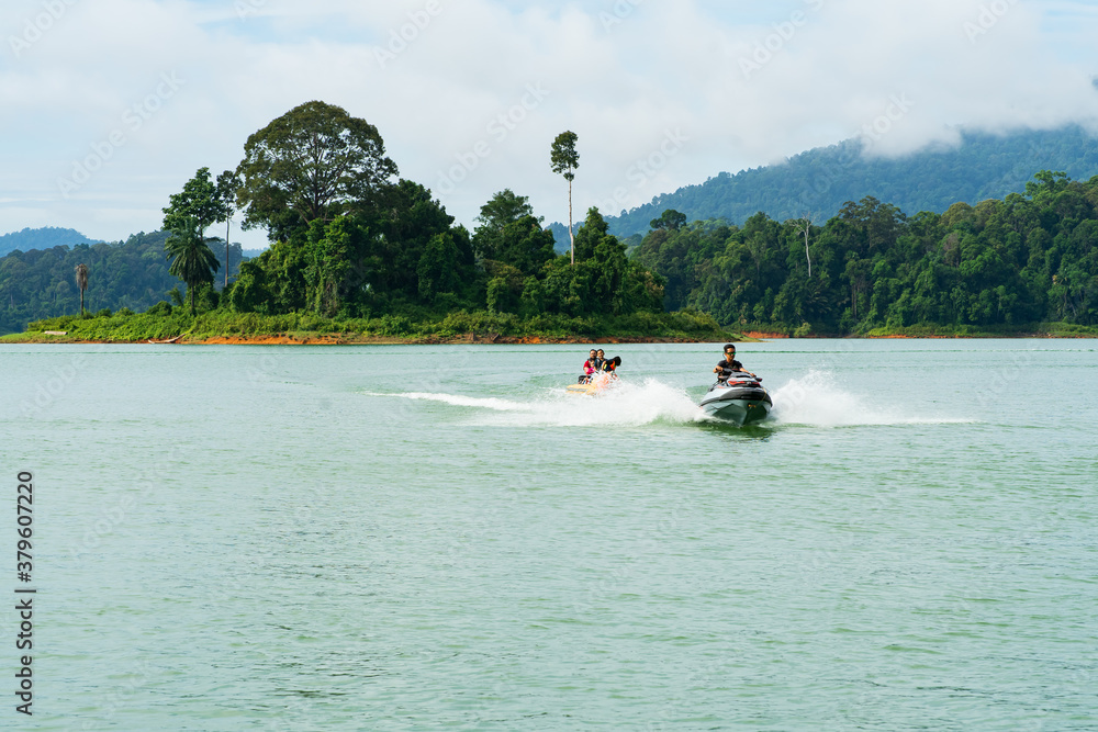 People enjoying water activities on banana boat at the Kenyir Lake, Terengganu, Malaysia.