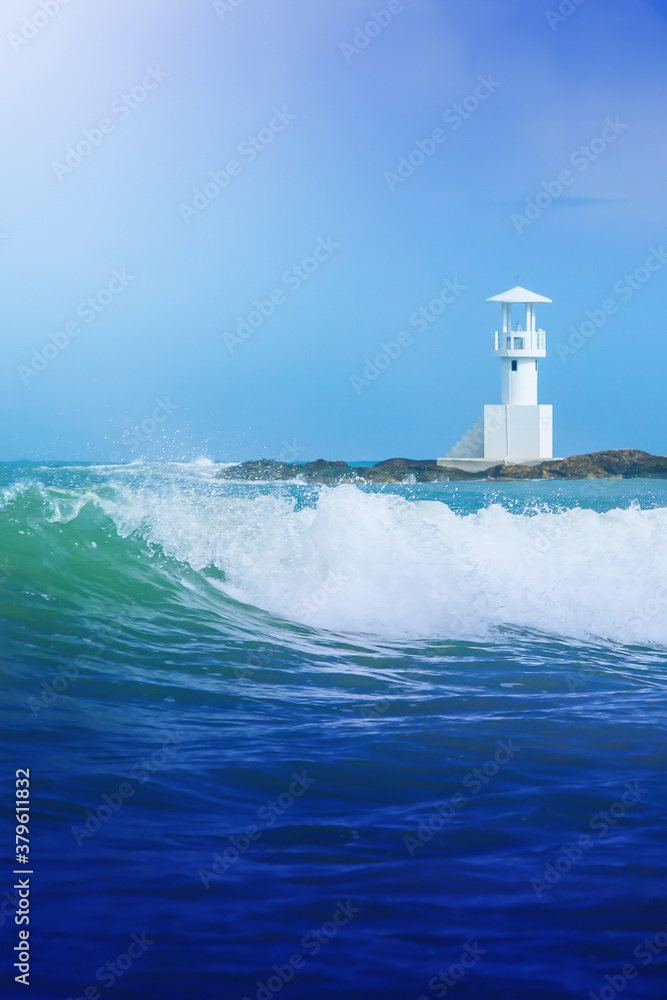 Rushing ocean waves and the white lighthouse.