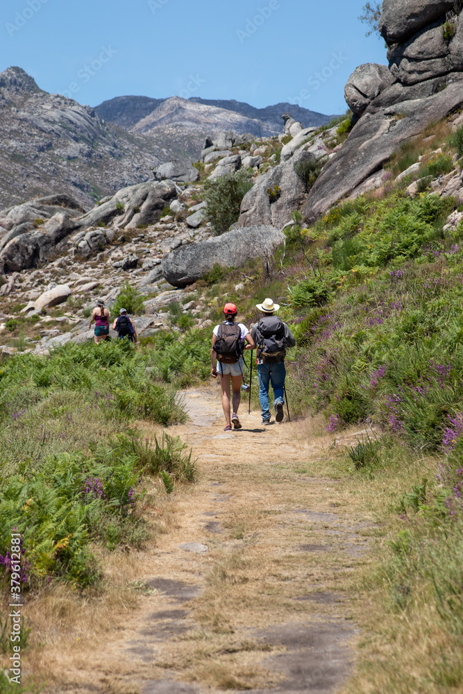 Four mountain hikers in the heart of Serra do Geres, Braga, Portugal