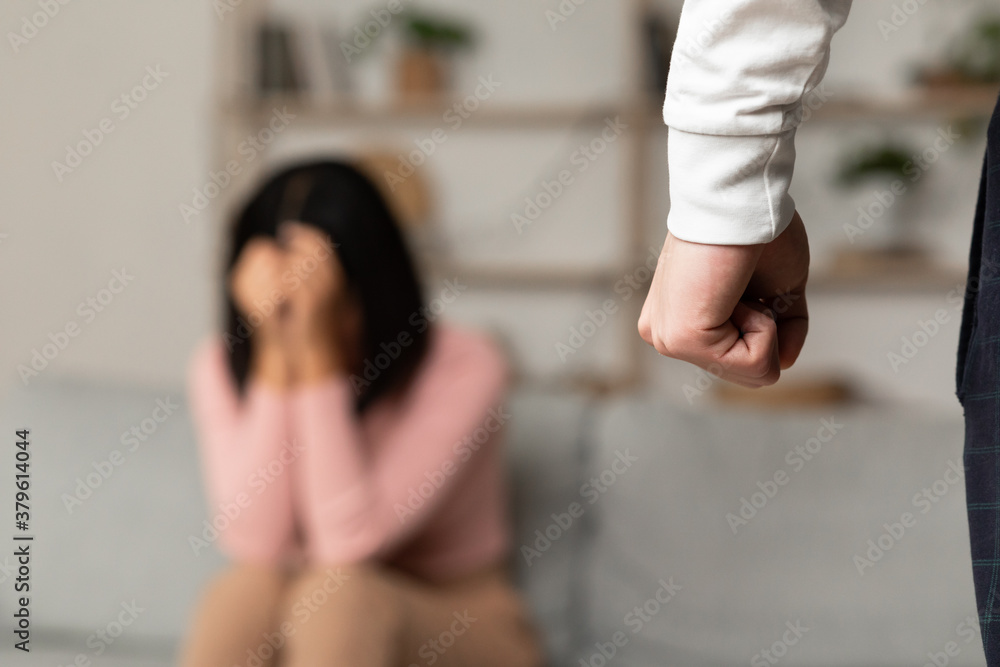 Domestic Abuse, Angry Asian Husband Clenching Fist Threatening Wife Indoors Domestic Abuse, Angry Asian Husband Clenching Fist Threatening Wife Indoors