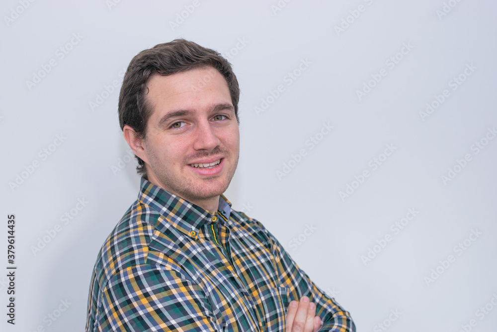 Photo of a young and attractive man wearing a shirt smiling at the camera looking very professional. Casual business man, corporative. Photo of a young and attractive man wearing a shirt smiling at the camera looking very professional. Casual business man, corporative.