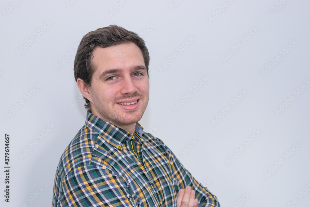 Photo of a young and attractive man wearing a shirt smiling at the camera looking very professional. Casual business man, corporative. Photo of a young and attractive man wearing a shirt smiling at the camera looking very professional. Casual business man, corporative.