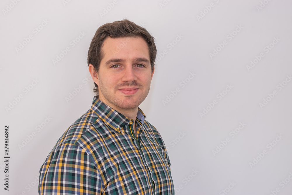 Photo of a young and attractive man wearing a shirt smiling at the camera looking very professional. Casual business man, corporative.