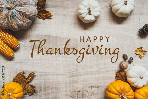 Happy Thanksgiving Day with pumpkin and nut on wooden table