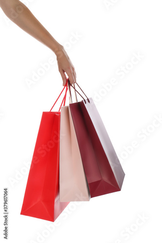 Woman with paper shopping bags on white background, closeup