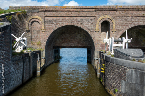 Old medieval sluice called the Aduarderzijlen first built in 1400 near Aduarderzijl, in the province of Groningen, the Netherlands. photo