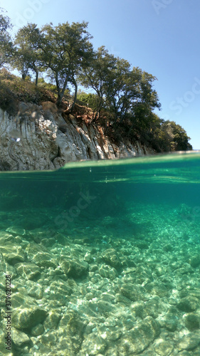 Fototapeta Naklejka Na Ścianę i Meble -  Sea level and underwater photo of beautiful pebble beach of Krovoulia near picturesque village of Frikes, Ithaki island, Ionian, Greece