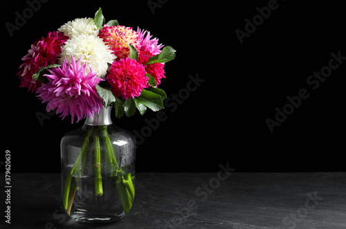 Wallpaper Mural Beautiful dahlia flowers in vase on table against black background. Space for text Torontodigital.ca