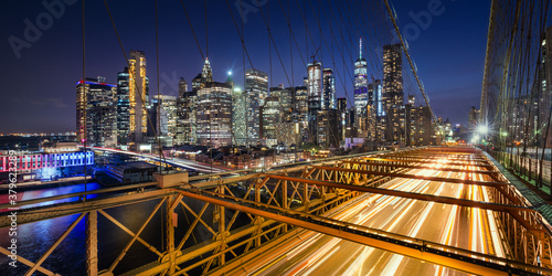 Tablou canvas Panoramic view on Lower Manhattan skyscrapers at Dusk and Brooklyn Bridge with light trails