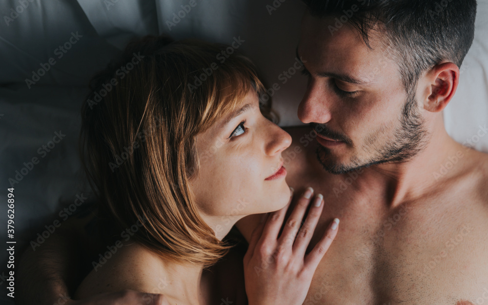 Romantic couple of lovers cuddling in the bed at home. Boyfriend and girlfriend in love. Romantic couple of lovers cuddling in the bed at home. Boyfriend and girlfriend in love.