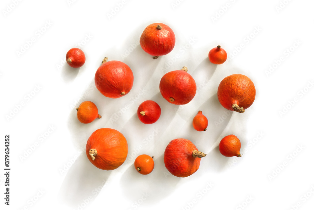Fresh raw fruits red kuri squash ( hokkaido ) on a white background. Top view, flat lay Fresh raw fruits red kuri squash ( hokkaido ) on a white background. Top view, flat lay