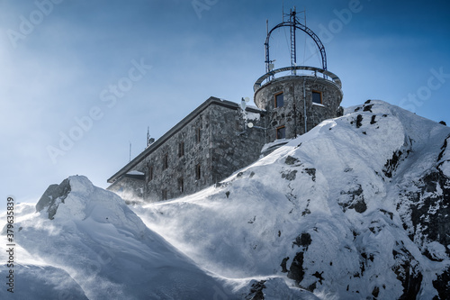 Meteorologic station with transmission antennas on the top of Kasprowy Wierch mountain in rough winter conditions, Poland