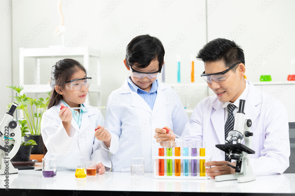 science teacher doing or testing a chemical experiment with child students in laboratory classroom science teacher doing or testing a chemical experiment with child students in laboratory classroom