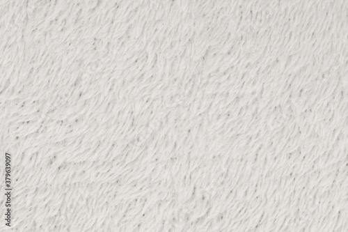 White natural wool with white texture background. white seamless woolen plaid. texture of fluffy fur for designers, close-up fragment white wool carpet