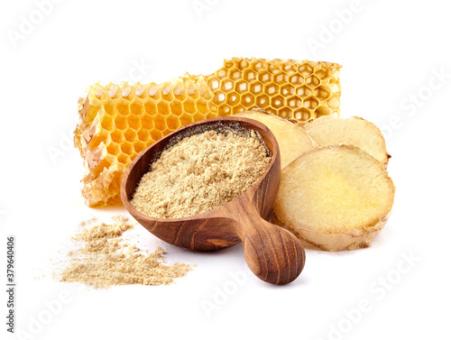 Honeycomb with ginger in wooden spoon on white background closeup. Honey with spice.