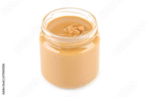 Peanut butter in glass jar isolated on white background