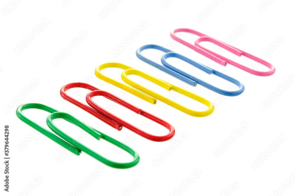 Collection of colorful paper clips isolated on white background. Colored paper clips on a white background. Five paper clips in a row isolated on a white background. Collection of colorful paper clips isolated on white background. Colored paper clips on a white background. Five paper clips in a row isolated on a white background.