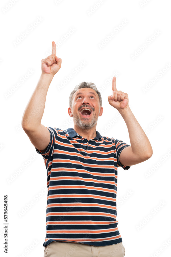 Excited adult model pointing index fingers at copyspace above head Excited adult model pointing index fingers at copyspace above head
